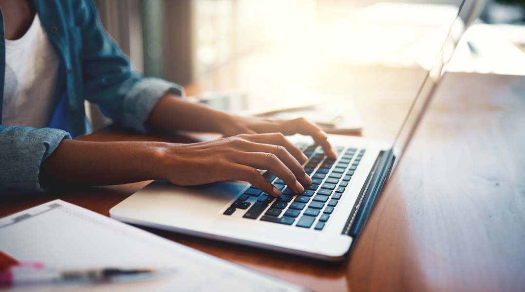 Person typing on keyboard - Trinity Health - Hand and Wrist Surgery