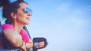 Woman leaning out of car | Allerygy and Immunology | Trinity Health
